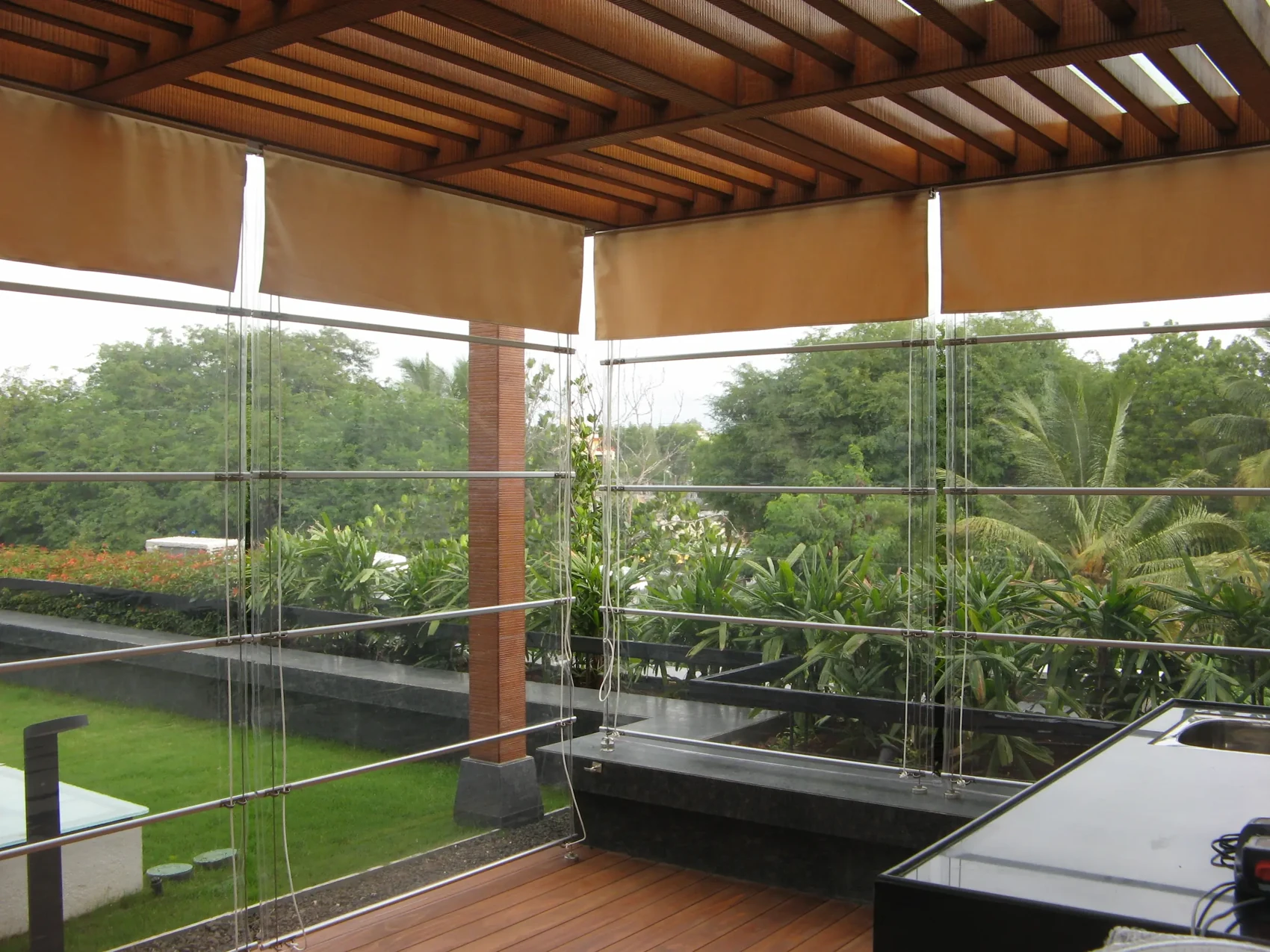 Monsoon blinds around a covered terrace with garden views